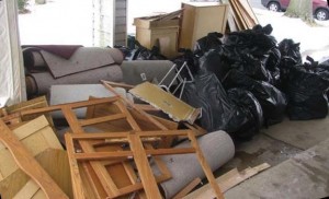 Large debris pile including kitchen cabinets, carpet  and personal belongings
