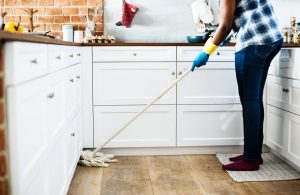 A woman mopping a floor