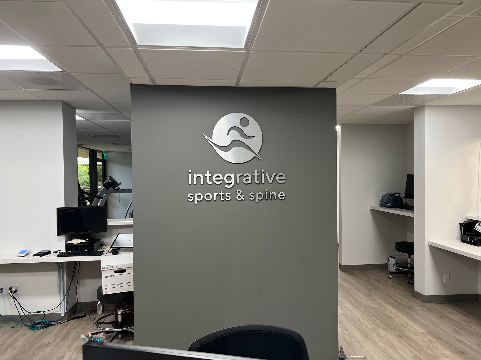 Our team visited Integrative Sports and Spine at the beginning of the year. The client asked our shop to create window graphics as a low-cost advertising solution. Now, the client invited us to return and fabricate one of our brushed metal lobby logo signs for offices in Long Beach CA