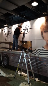 Mike Waggoner adding graphics to the Taylor Swift tour bus exhibit for 1220 Exhibits and the Country Music Hall of Fame and Museum