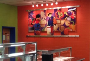 This photo shows one of two murals we installed at Page Middle School in Franklin, TN. The bright wall color really makes this mural POP!