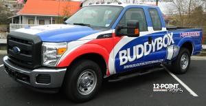 This angle offers a view of the brand colors and details that were included on the wrap design. The bold white lettering on the side of the truck really makes the name stand out.