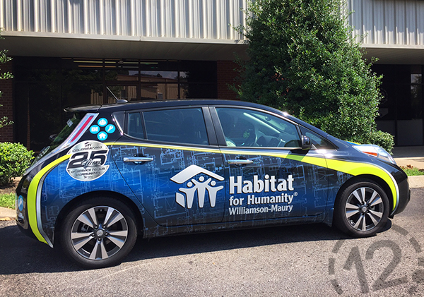 This custom advertising wrap contains blueprints in the background, as well as the organization's logo, contact information, and 25th anniversary mark. 12-Point SignWorks - Franklin, TN