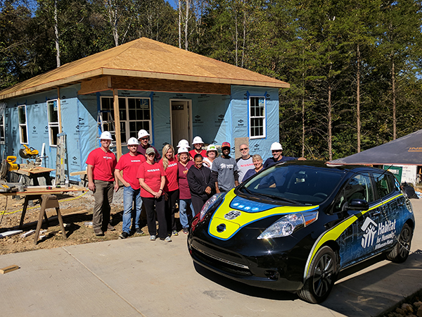This photo shows volunteers from Nissan at the construction site, along with the newly wrapped Nissan Leaf. 12-Point SignWorks - Franklin, TN