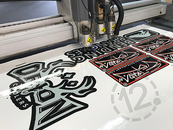 Kiss cut tool cutting vinyl stickers on our flatbed cutter. 12-Point SignWorks - Franklin, TN