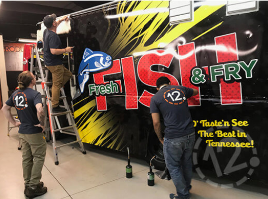 Custom food truck wrap installation for Fresh Fish & Fry. 12-Point SignWorks - Franklin, TN