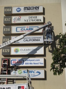 Fluorescent sign service with a bucket truck