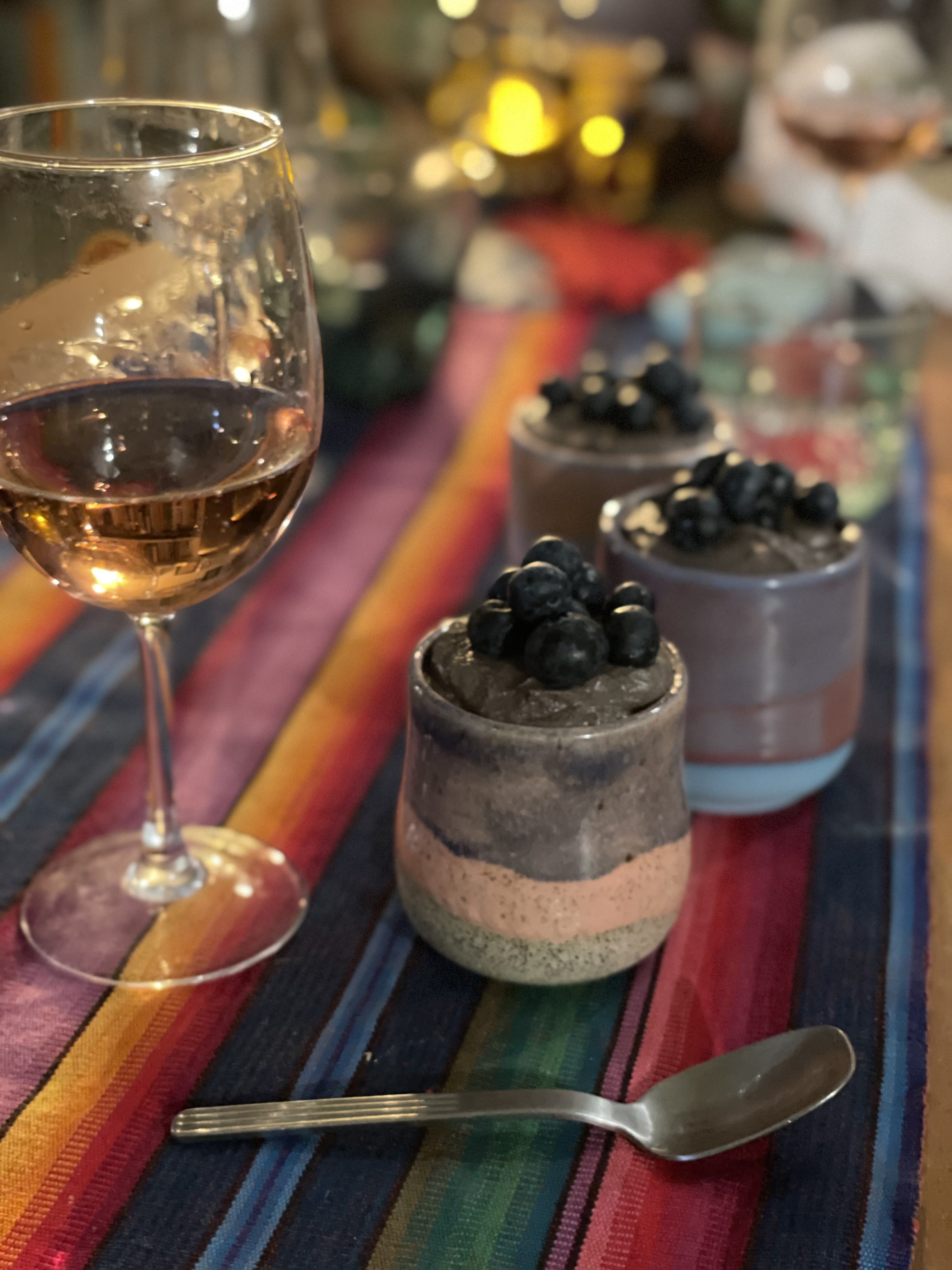 Small ceramic vessel with chocolate coconut cream mousse and topped with blueberries
