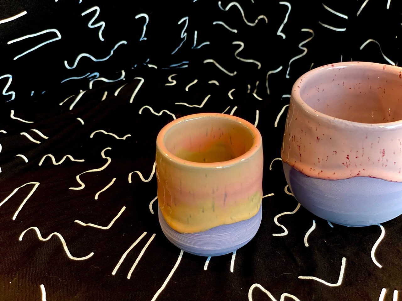 Purple porcelain cups with yellow and pink glazes
