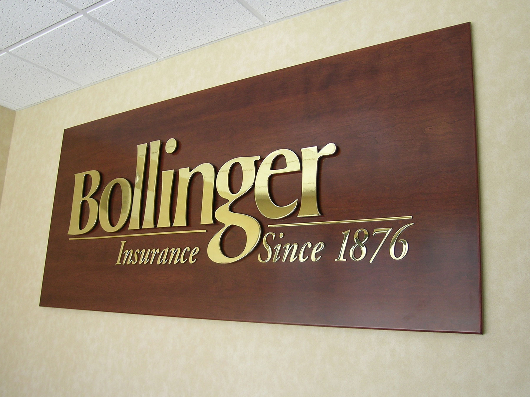 Brass logo mounted on cherry installed in NJ and NY