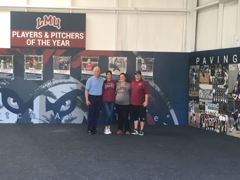 LMU Athletic director softball coach and staff in front of new wall mural in Los Angeles