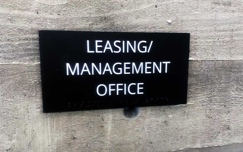 Custom Made Black and White ADA Signs for Watermark Apartments in Reseda, CA