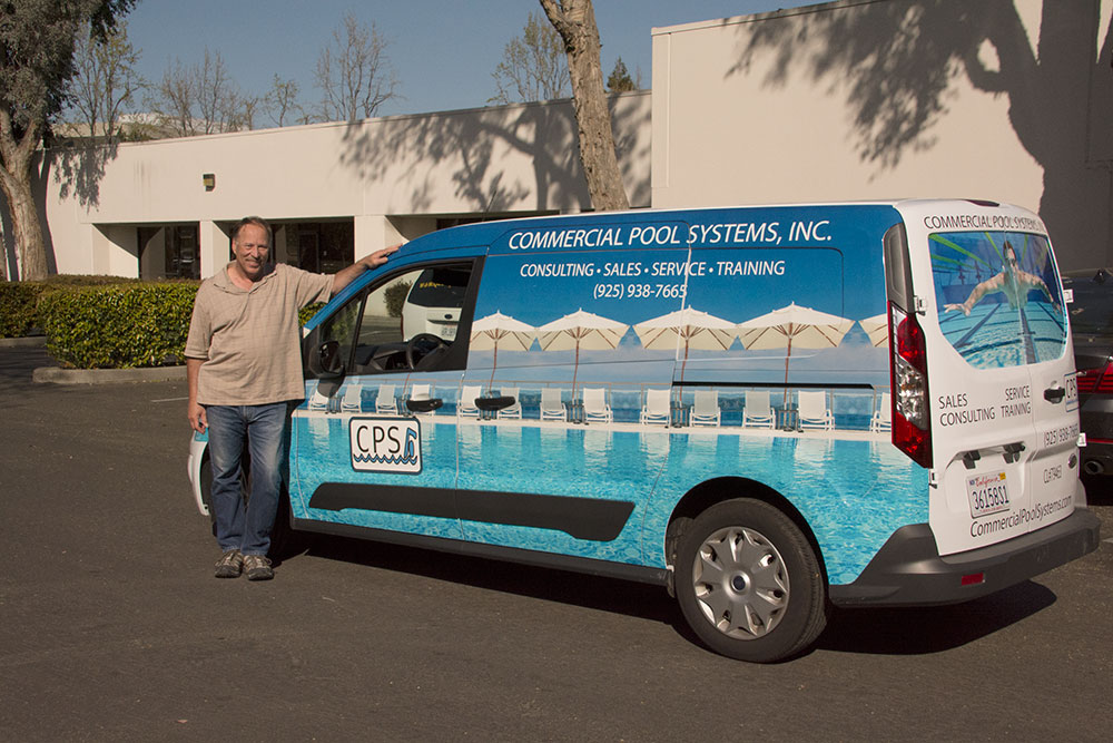 Owner of Commercial Pool Supply meeting his new van wrap for the first time