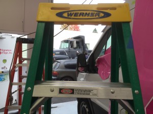 Vic works on cut graphics for Get it Done Hauling while All American Plumbing gets a special pink wrap