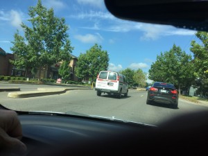 Can you read a sign on the rear window of this van?