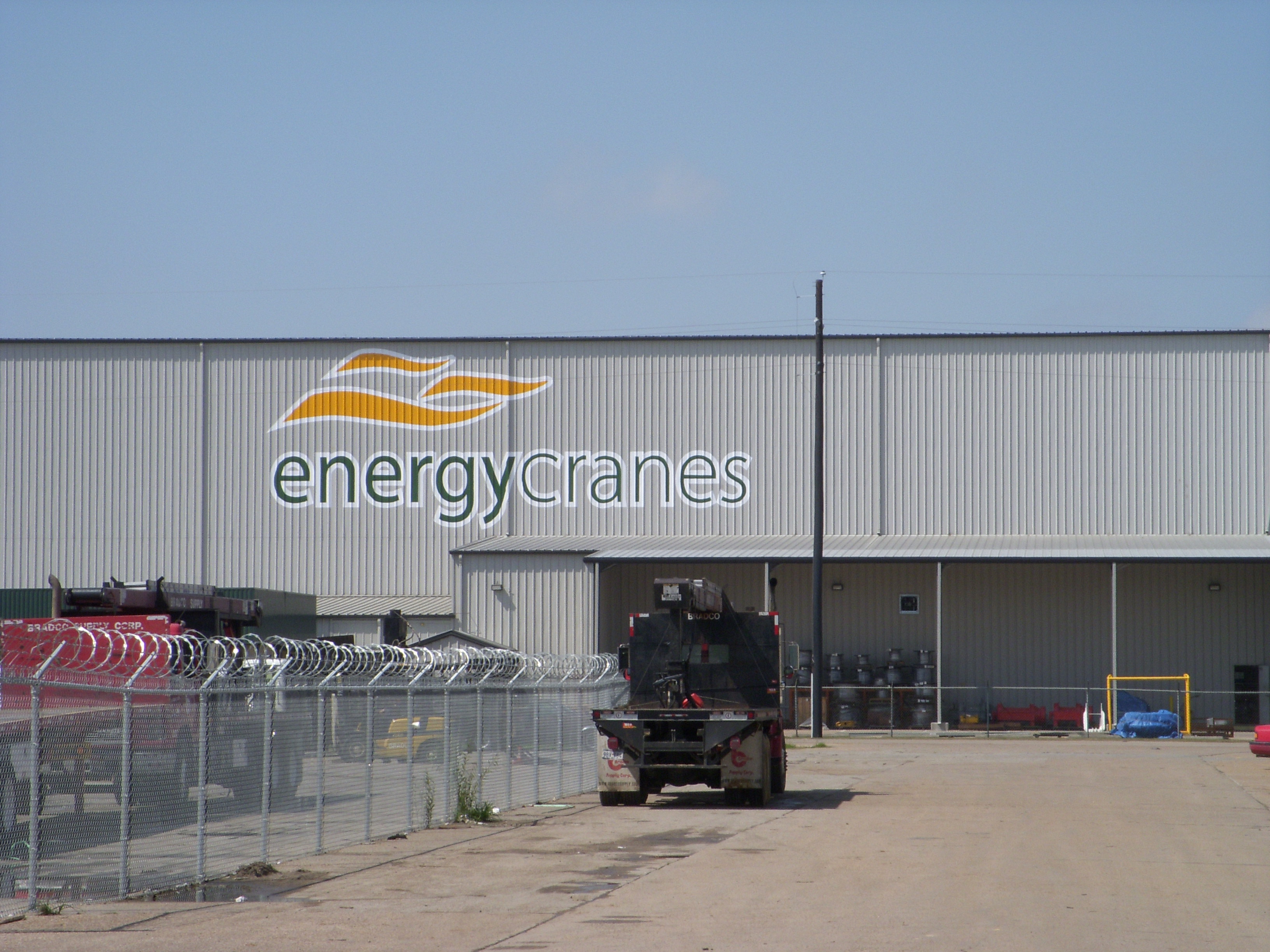 Hand painted logo on new building in Houston, TX for Sparrows Group, L.L.C.