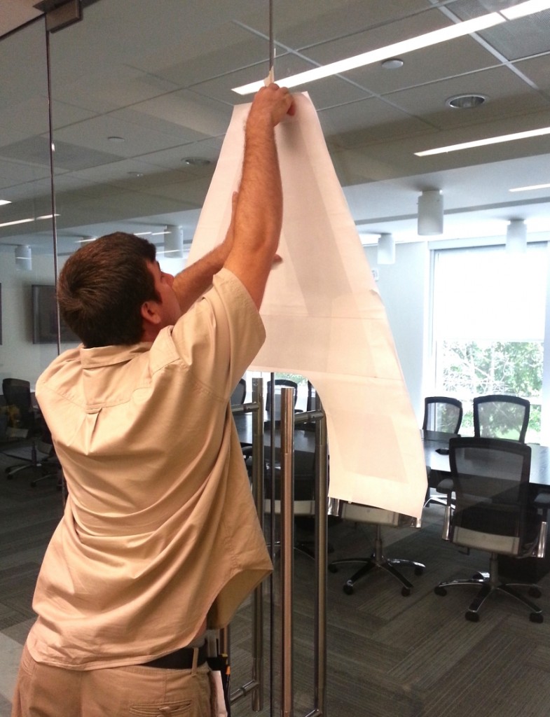 Precision installation of Frosted film Corporate logo for  Accudyne industries worldwide headquarters