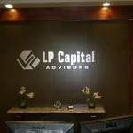 Externally lit lobby sign with metal letters and logo