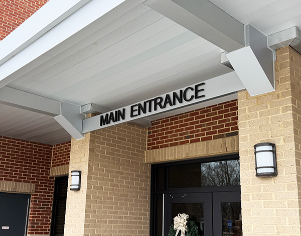 Main entrance sign lettering installed at East Hall High School showing bold MAIN ENTRANCE identification above exterior doors in Georgia