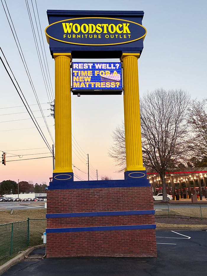 Woodstock Furniture Outlet monument sign with digital readerboard and decorative columns by Signs & More in Metro Atlanta Georgia