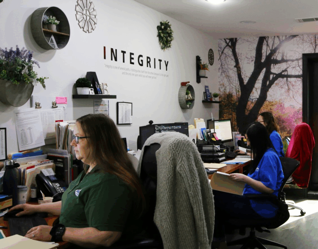 Signs & More customer service team in Metro Atlanta office with integrity values providing phone support for commercial signage projects