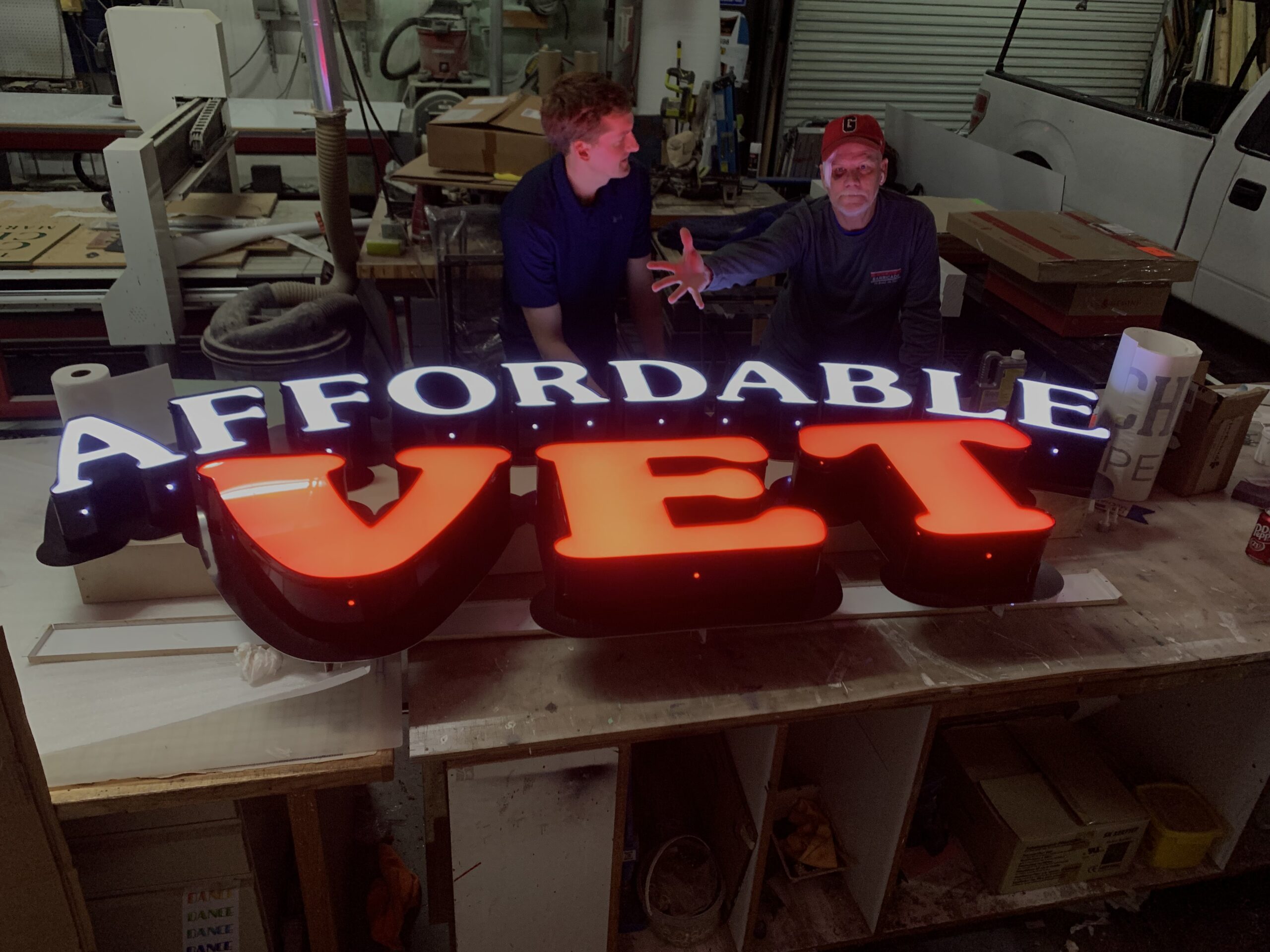 Illuminated “Affordable Vet” channel letter sign being assembled in a sign shop