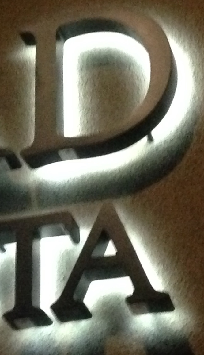 Halo Channel Letters cast a light on the wall behind them