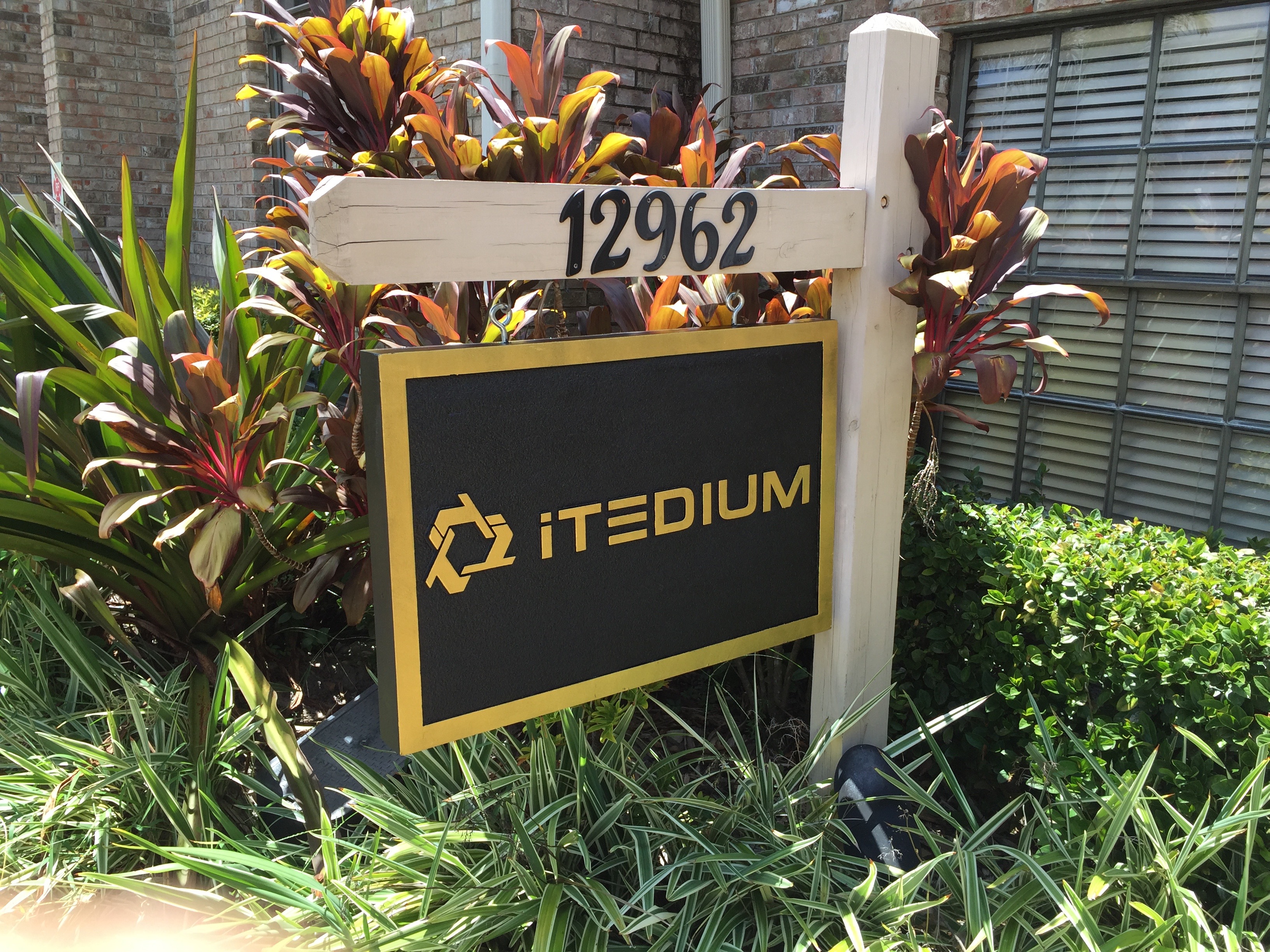 Tampa, FL – Outdoor Sign for Itedium: Custom HDU Foam Black & Gold Hanging Sign