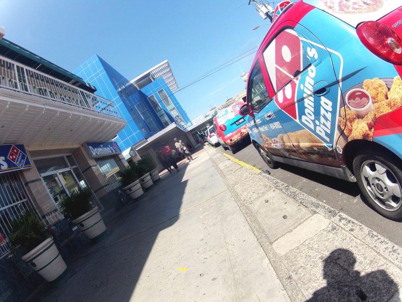 Domino's Pizza vehicle parked near business
